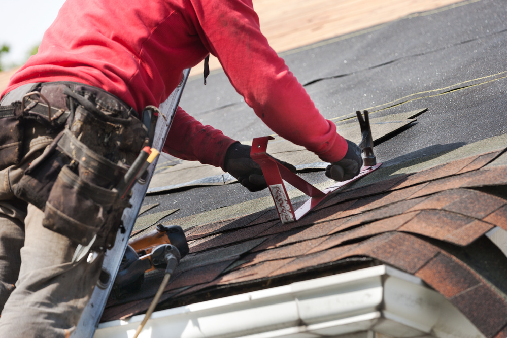 roofers installing new roof on house